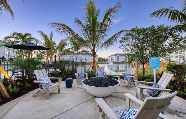 A patio with chairs and a bowl of fruit.