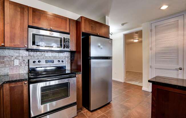 A kitchen with a stainless steel refrigerator and oven.