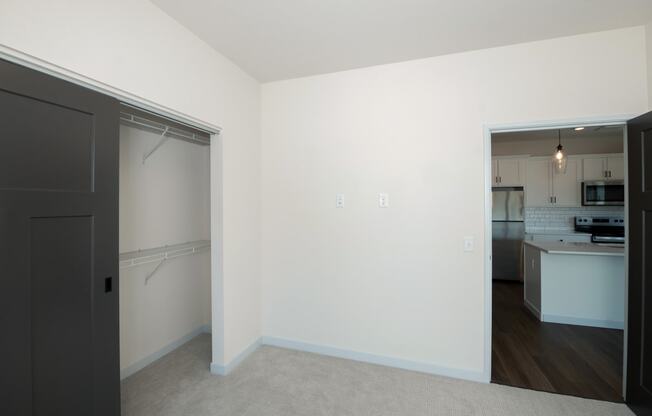a bedroom with a door to a kitchen and a living room at The Crossings at Windsong, Arizona