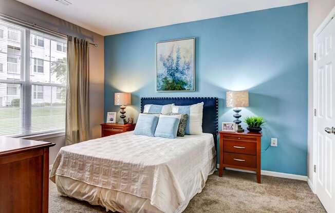 a bedroom with a bed and two night stands at MetroPlace at Town Center, Camp Springs, Maryland
