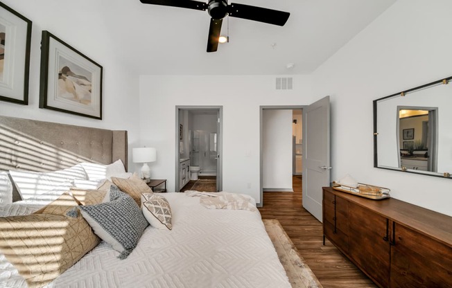 a bedroom with a large bed and a ceiling fan at The BLVD at Wilson Crossings, Wyoming, Michigan