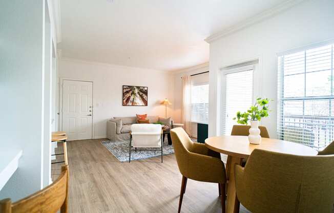 a living room and dining room with a couch and a table