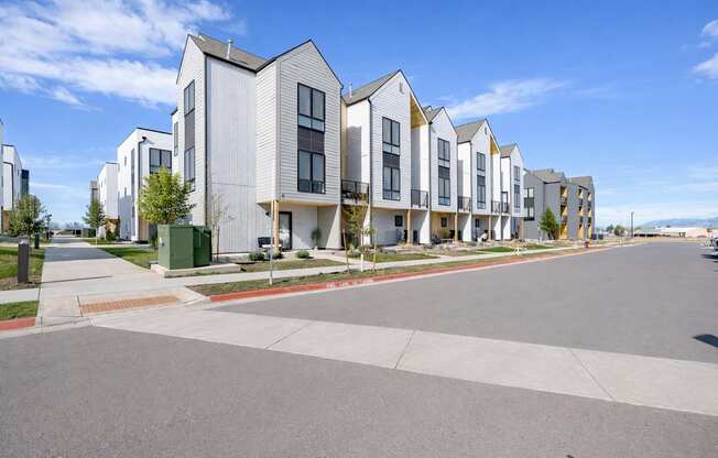 A row of modern houses with a clear blue sky above.