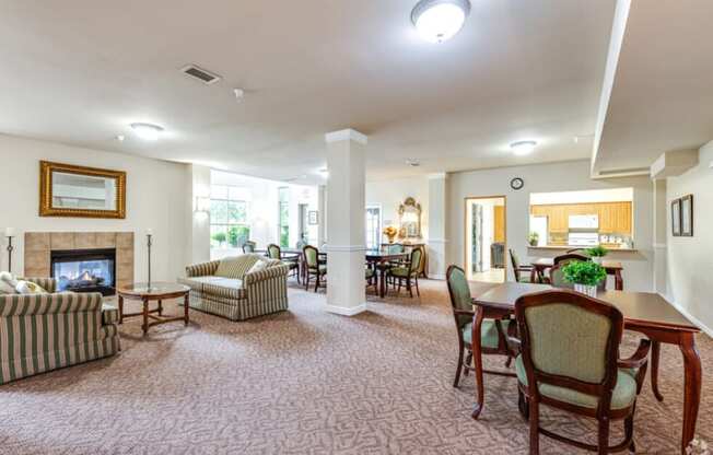 community room with a fireplace and a dining table