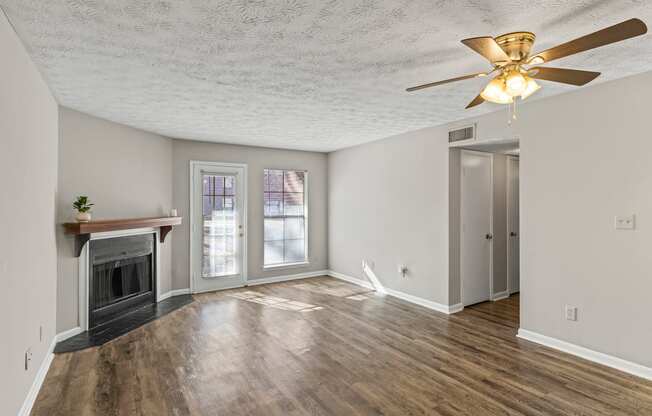 A room with a fireplace and a ceiling fan.