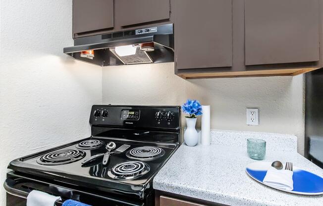 a stove top oven sitting inside of a kitchen counter