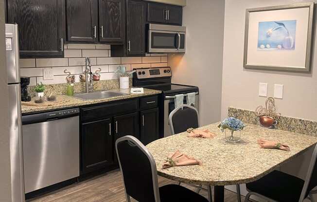 Fusion Orlando - Studio Kitchen with Stainless Steel Appliances and Dining Table