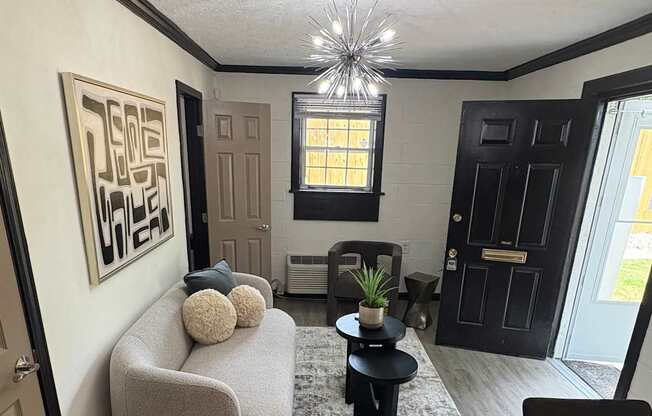 A modern living room with a grey sofa and a rug with the word