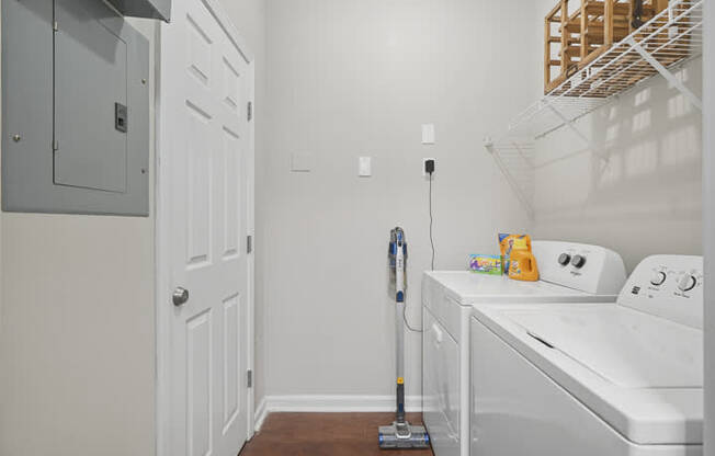 A white washer and dryer in a small laundry room.