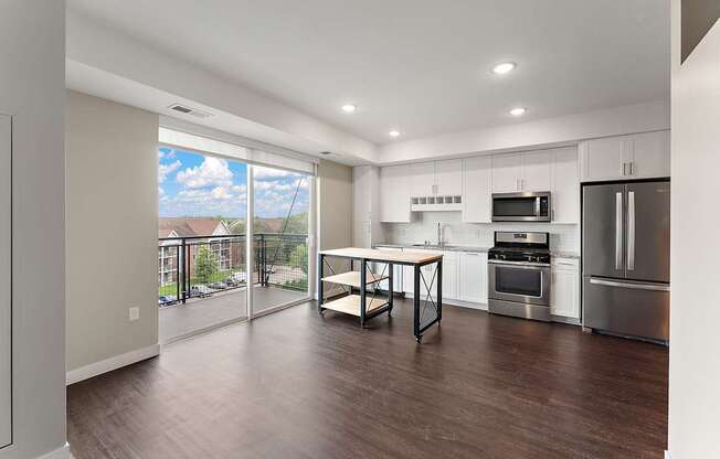 A modern kitchen with a dining table and chairs.