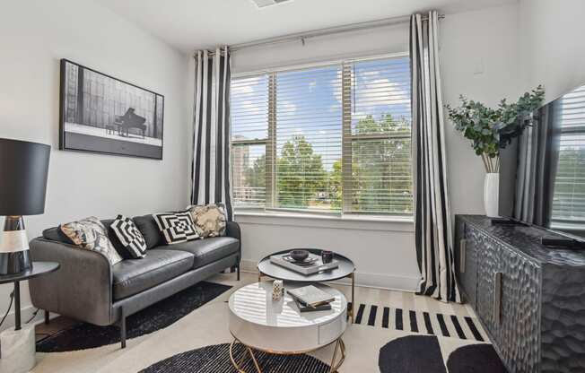 a living room with a couch and a coffee table at Link Apartments® Mint Street, Charlotte, NC, 28203