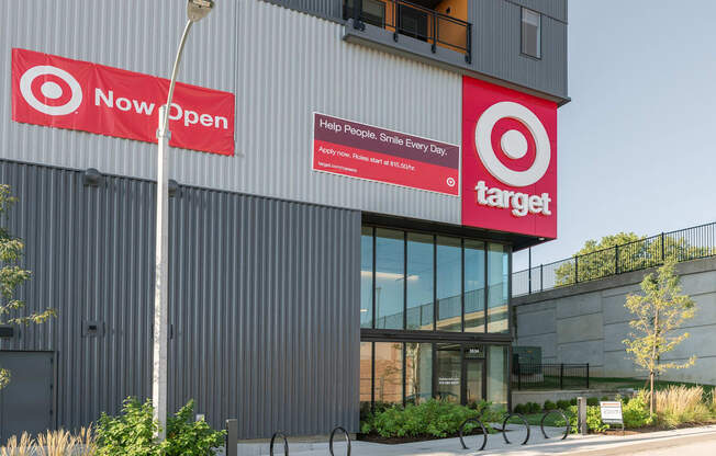 the exterior of a building with two red signs on the side of it