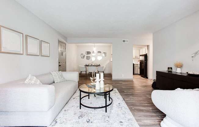 A living room with a white couch and a coffee table.