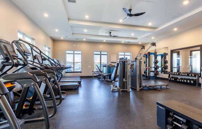 A spacious gym with treadmills, elliptical machines, and other exercise equipment.