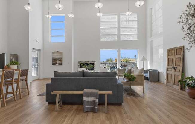 a living room with a gray couch and a dining room table