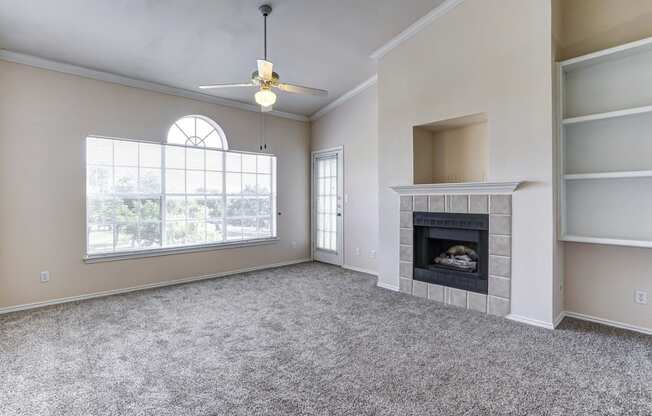 Bright and spacious living rooms with fireplaces at Turnberry Isle Apartments in Dallas, TX.