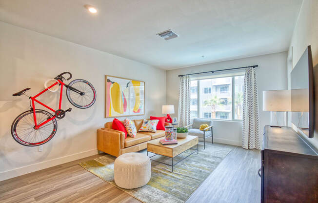 a living room with a couch and a bike on the wall