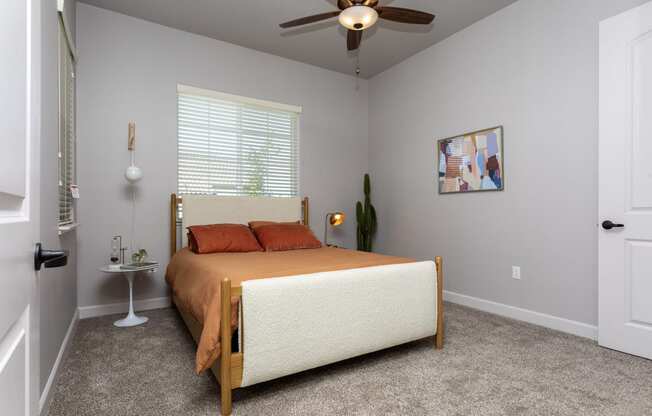 a bedroom with a bed and a ceiling fan