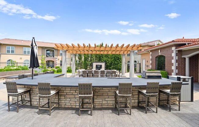 a large outdoor entertaining area with a bar and tables