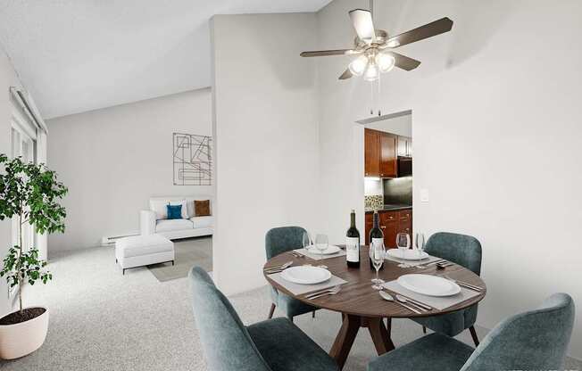 A dining room with a table set for two and a potted plant.