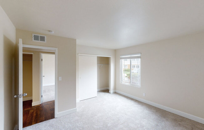 a bedroom with white carpet and white walls