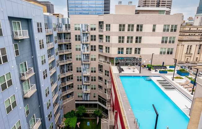 a large swimming pool in front of a tall building