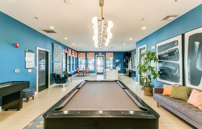 a game room with a pool table and a couch