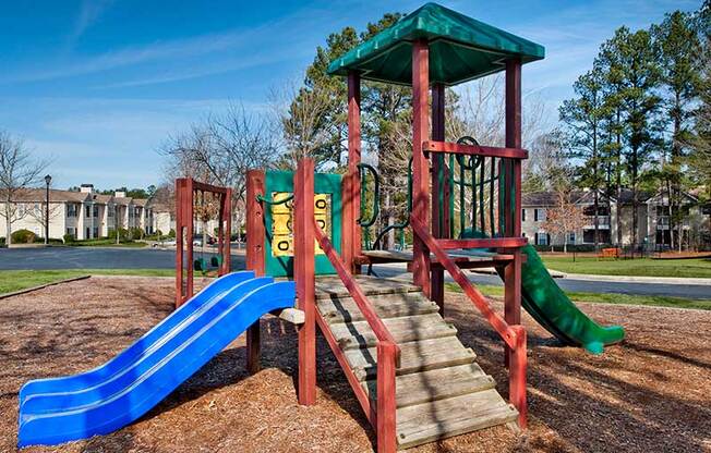 a playground with a blue slide and