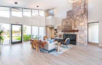 A living room with a stone fireplace and a couch.