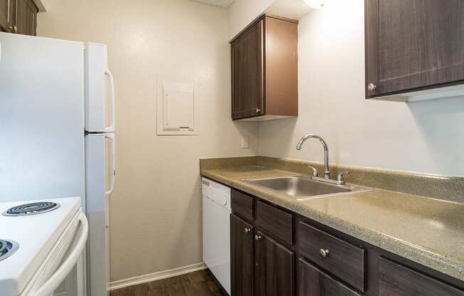 a kitchen with a sink and a refrigerator