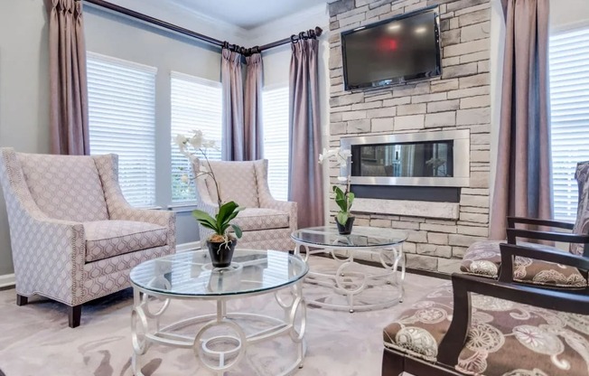 a living room with a fireplace and a table and chairs