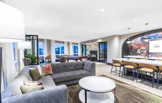 This expansive resident lounge offers plenty of space to gather, play, or unwind—with cozy seating, a pool table, and vibrant design accents throughout.