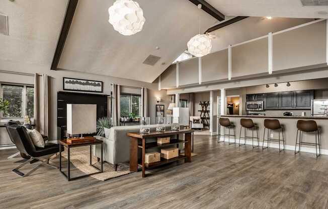 A modern living room with a bar area and a dining table