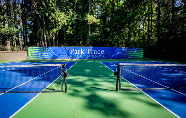 two tennis nets on a tennis court at park trace apartments