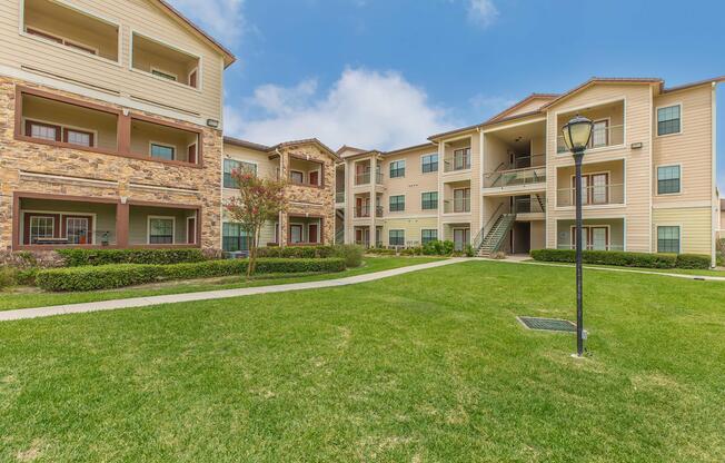 a large lawn in front of a brick building