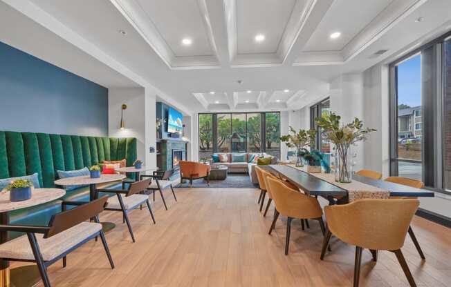 a lounge area with tables and chairs and a fireplace