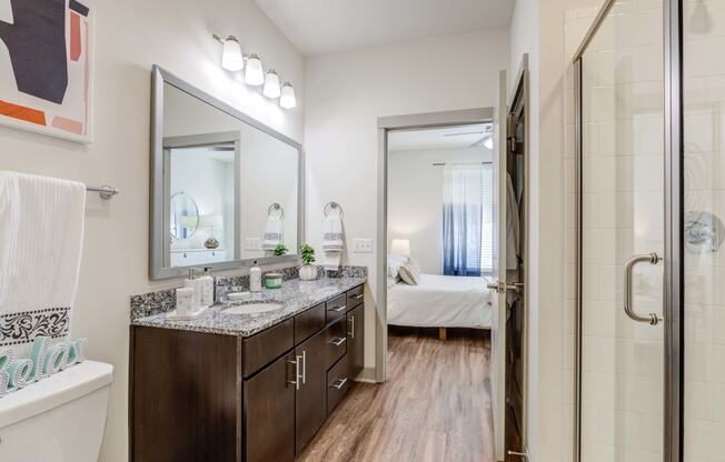 Carillon Apartments in Nashville, TN 37219 photo of a bathroom with a shower and a sink and a mirror