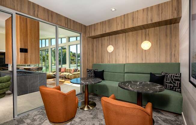 a living room with a green couch and two tables