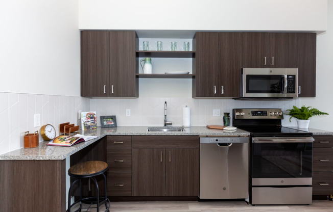 kitchen with stainless steel appliances, granite countertops, and wood-style cabinets