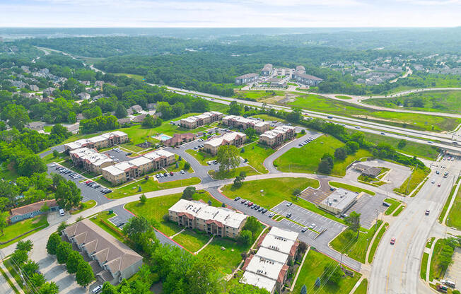 an aerial view of a city with buildings and cars on the street