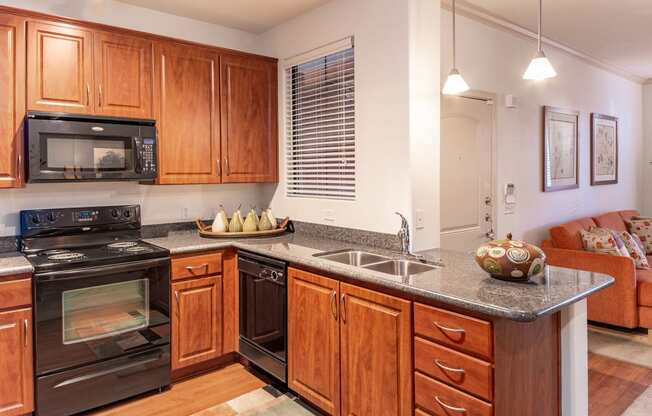 a kitchen with wooden cabinets and black appliances