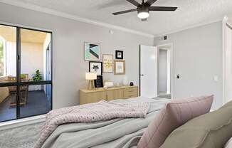 Carpeted bedroom with ceiling fan and natural light from adjacent patio.