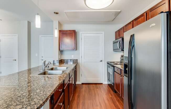 a kitchen with granite counter tops and stainless steel appliances