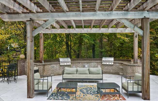 a patio with furniture and a wooden pergola