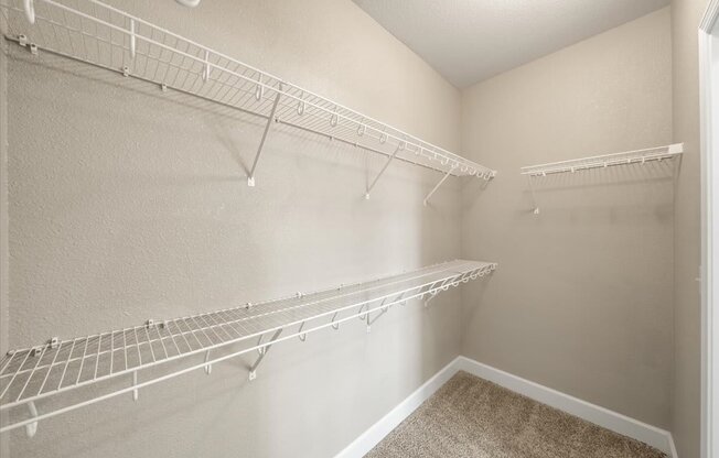 Empty white shelves in a room.