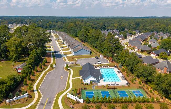 Bird’s-eye view capturing the clubhouse, community amenities, and surrounding homes.