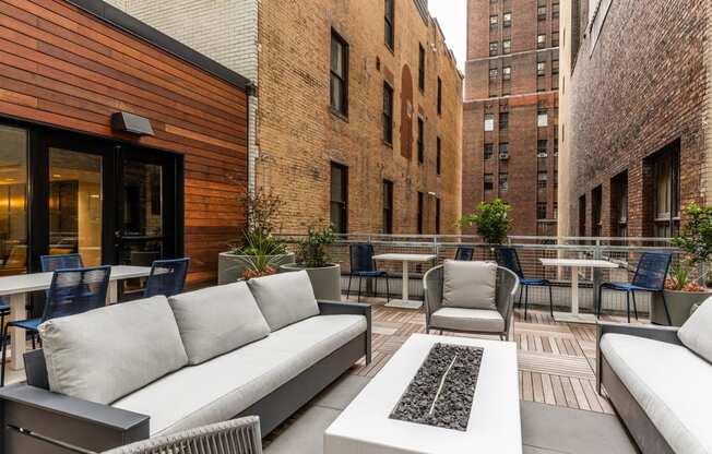 an outdoor patio with couches and chairs and tables at The Commonwealth Building, Pittsburgh, 15222