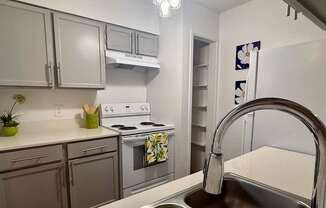 A kitchen with a stove, oven, and sink.