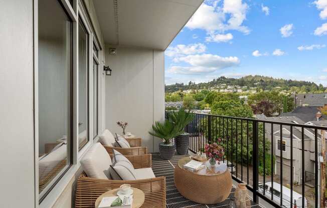 a balcony with a view of a city and a patio