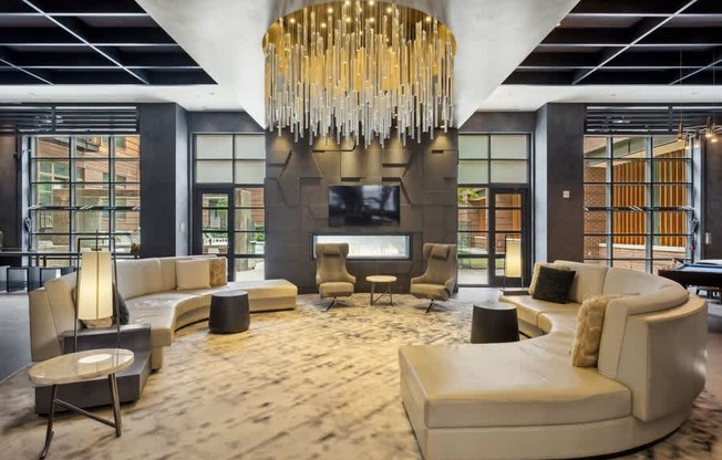 a large living room with a chandelier and a fireplace